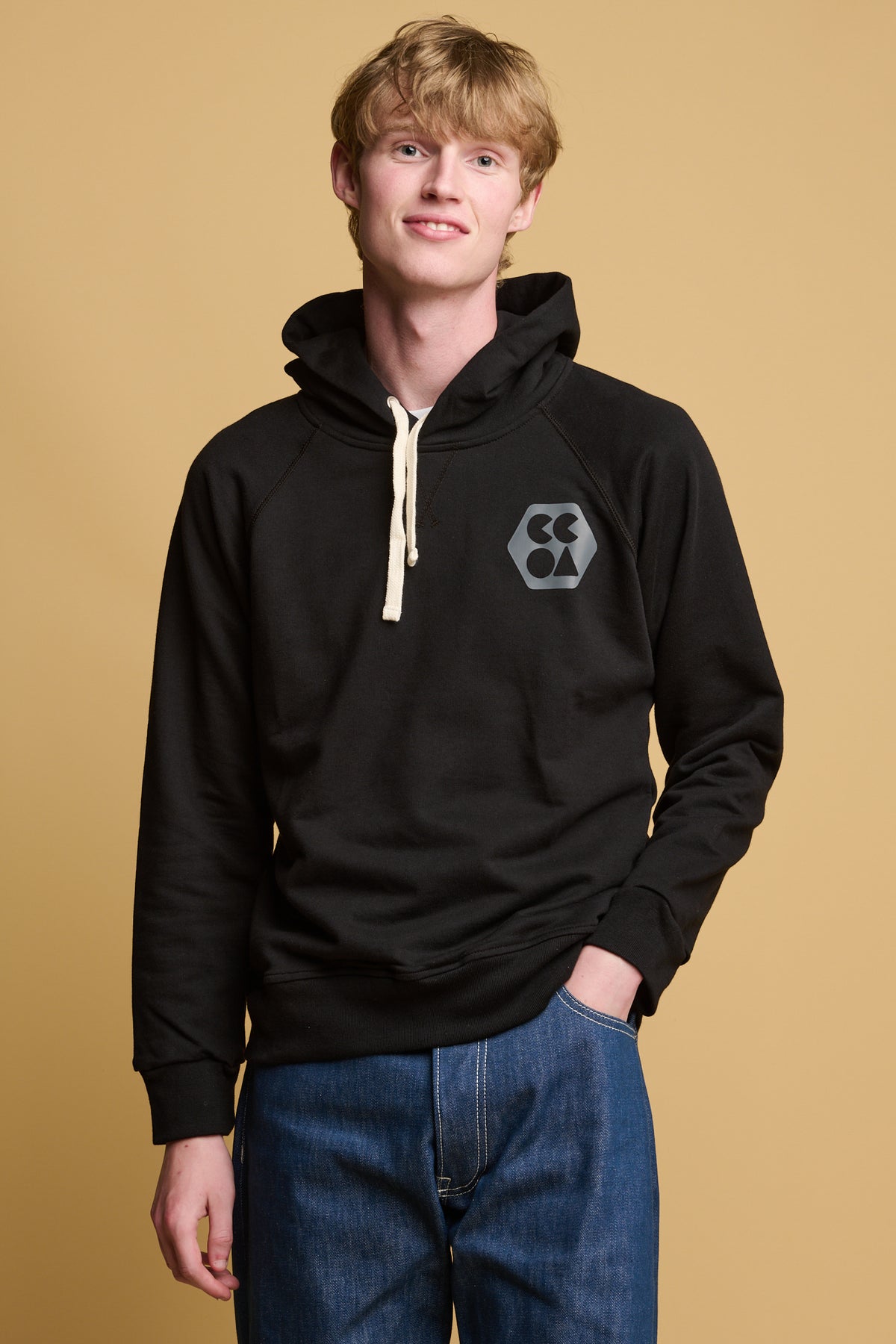 male wearing plastic free hoodie with CCOA kogo on chest paired with blue jeans