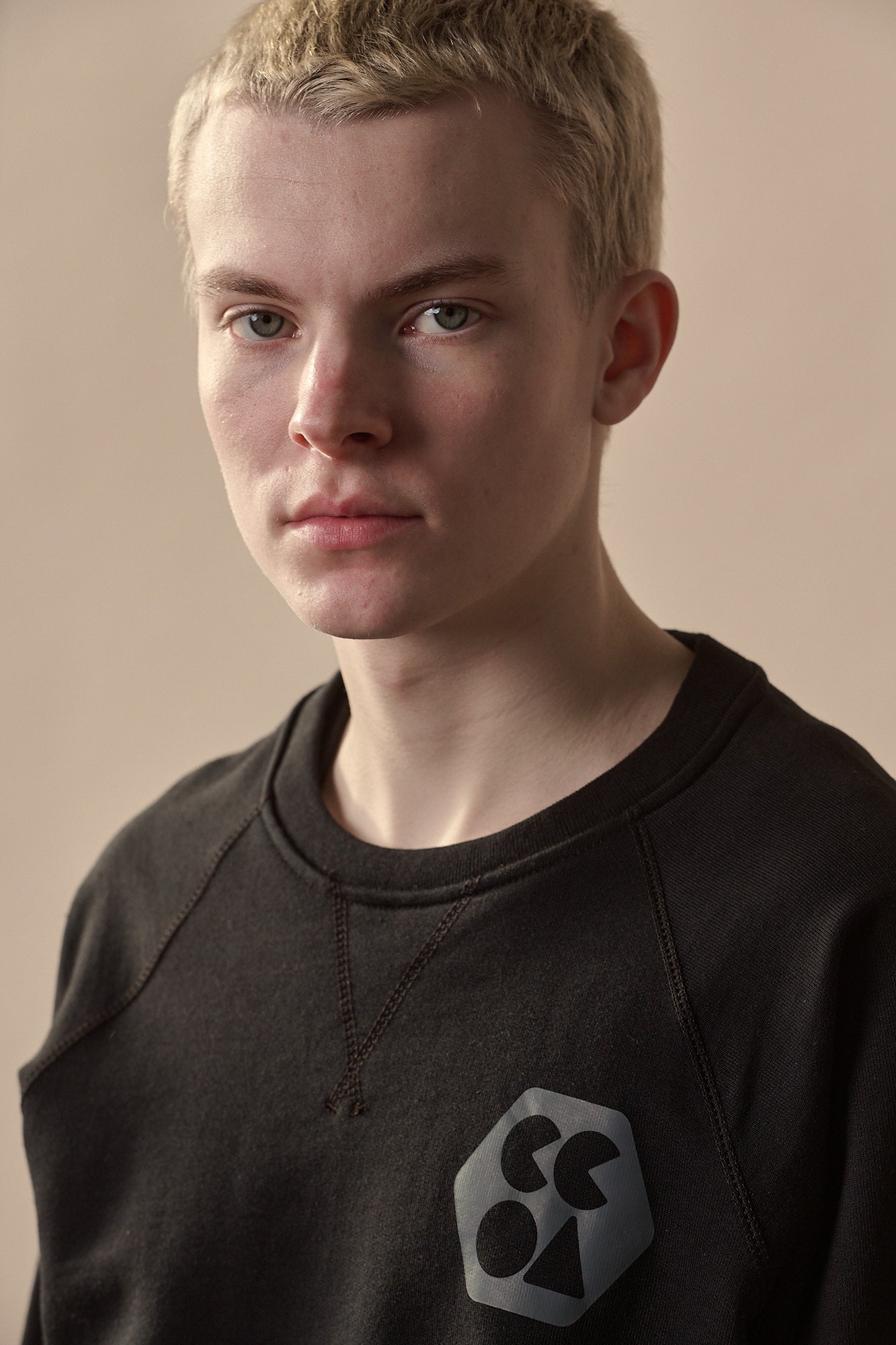 Thigh up image of white male wearing men's raglan sweatshirt plastic free with CCOA logo