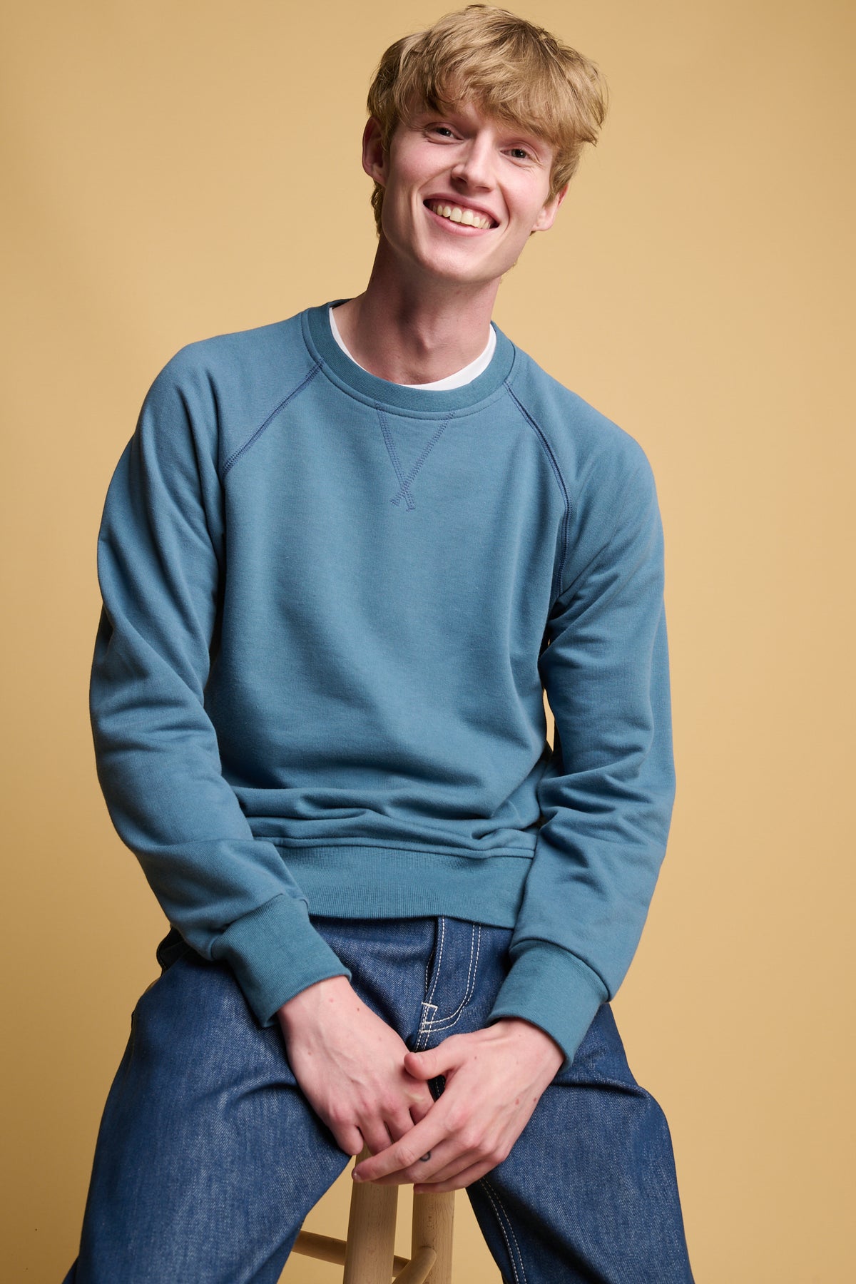 smiley male wearing RAF blue raglan sweatshirt 