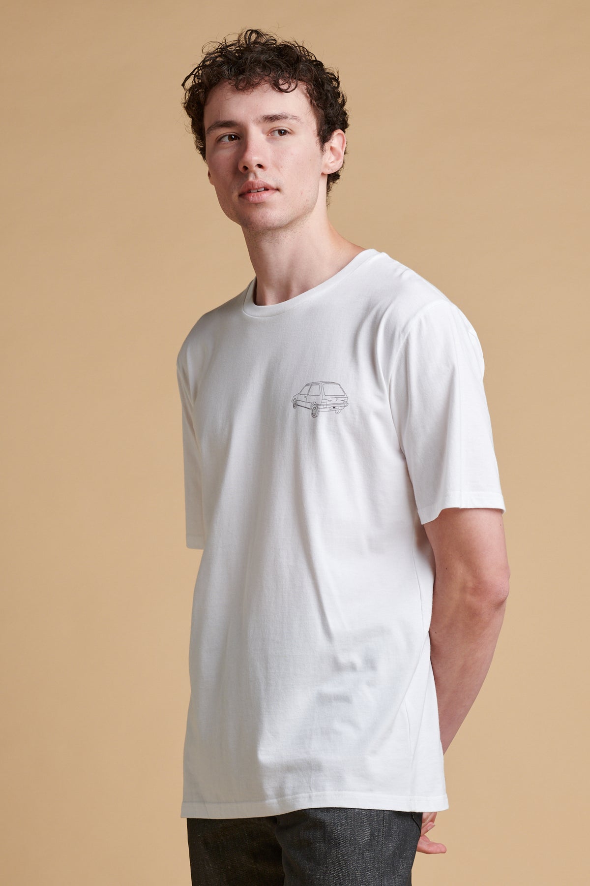 Male wearing short sleeve graphic t shirt with Metro car print.