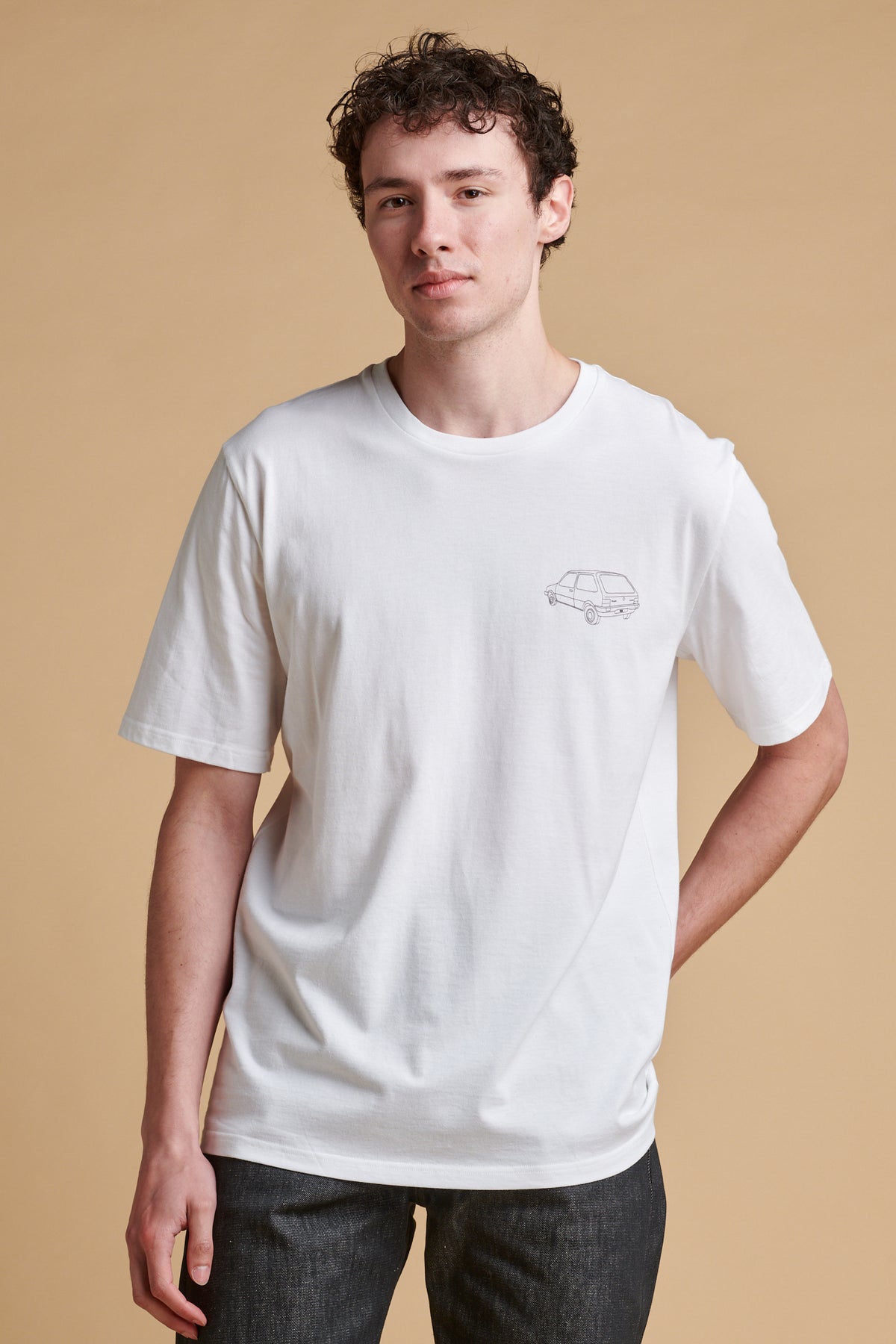Male wearing short sleeve graphic t shirt with Metro car print.