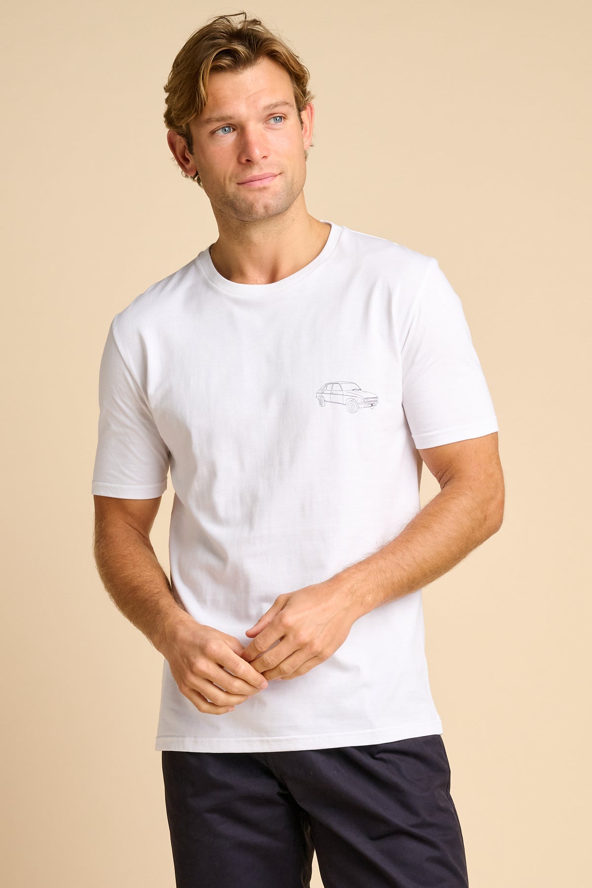 Man wearing a white t-shirt with a small graphic print.