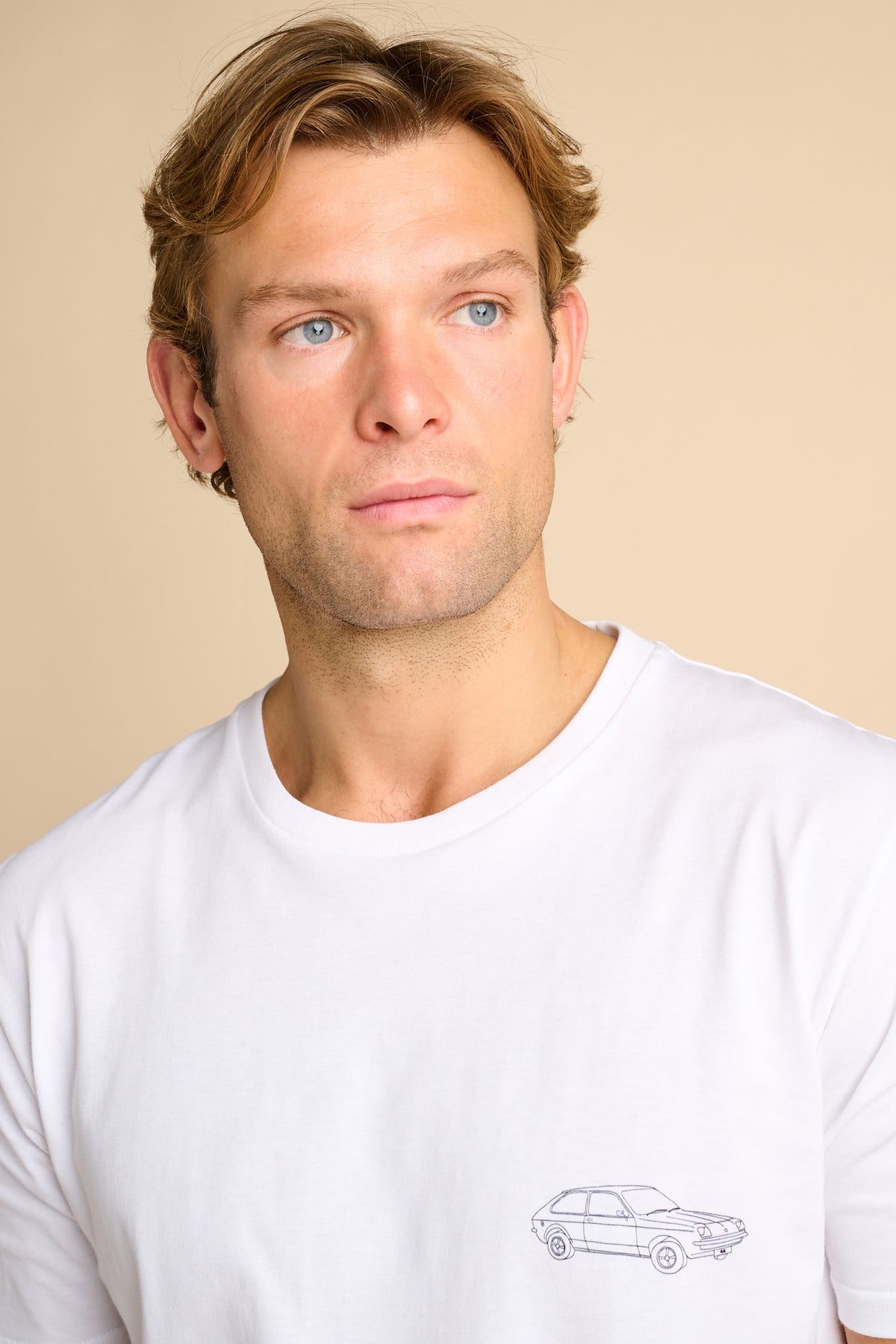Man wearing a white t-shirt with a small graphic print.