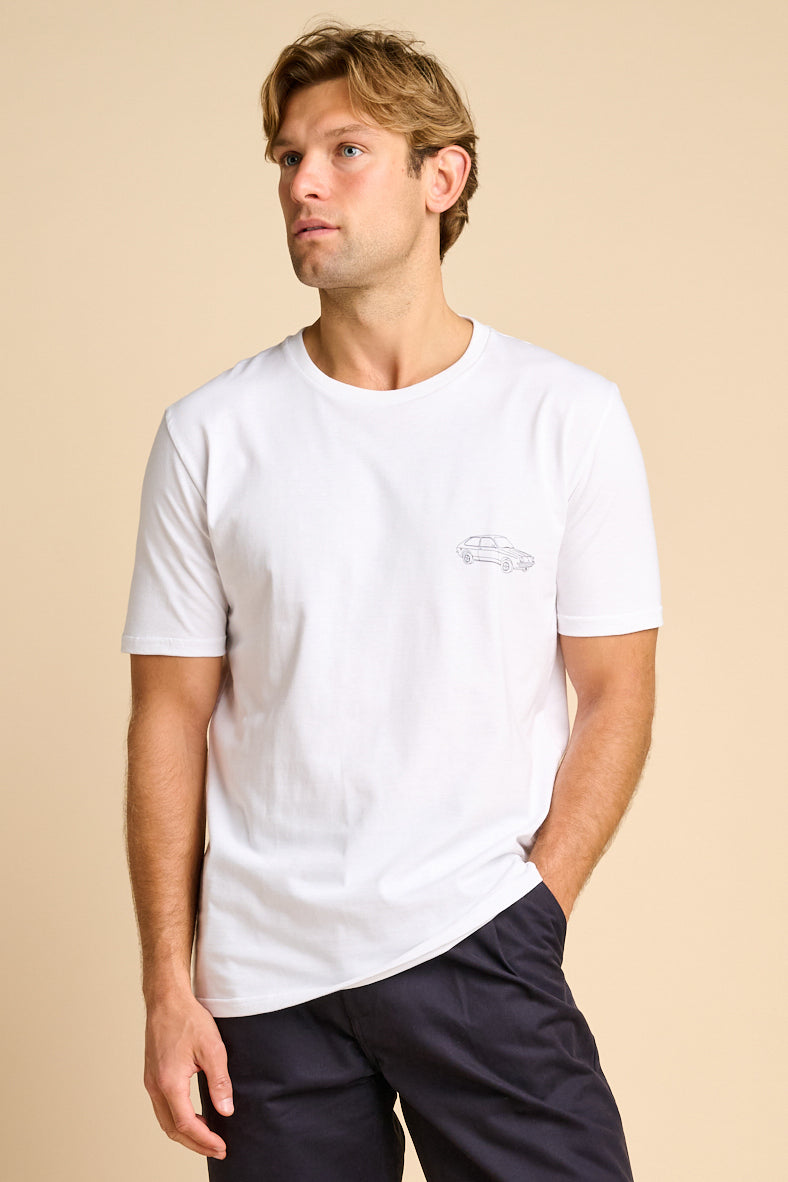 Man wearing a white t-shirt with a small graphic print.