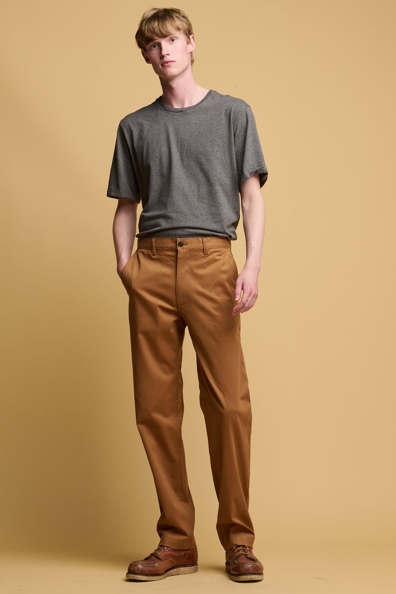 Shoulder down of male wearing community clothing slim  stretch chino in tobacco