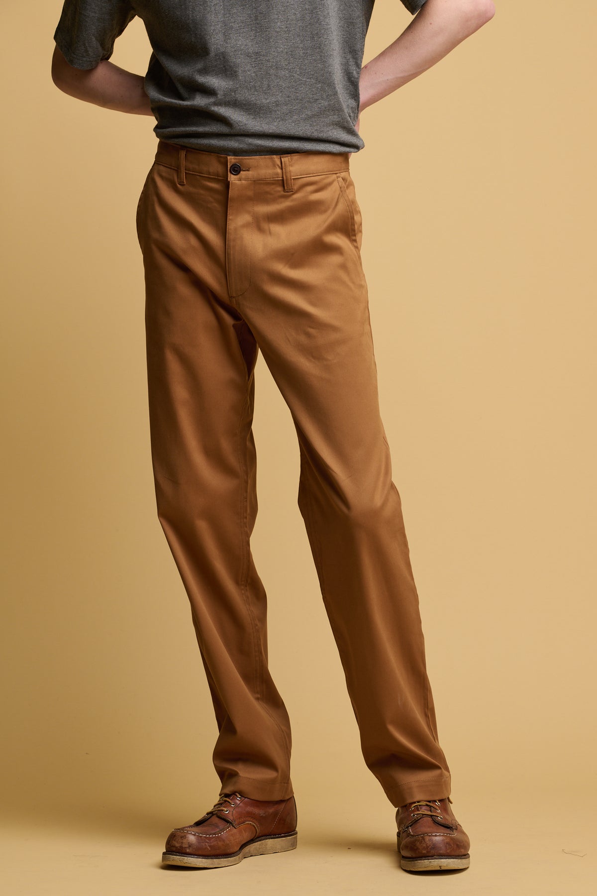 Shoulder down of male wearing community clothing slim  stretch chino in tobacco