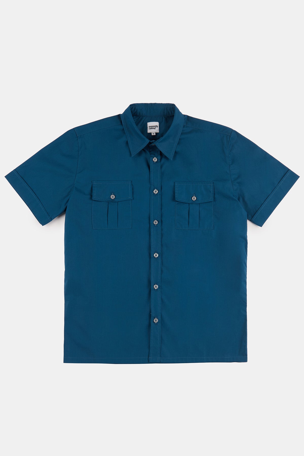 Flatlay product shot of men's short sleeve military two pocket shirt in light blue