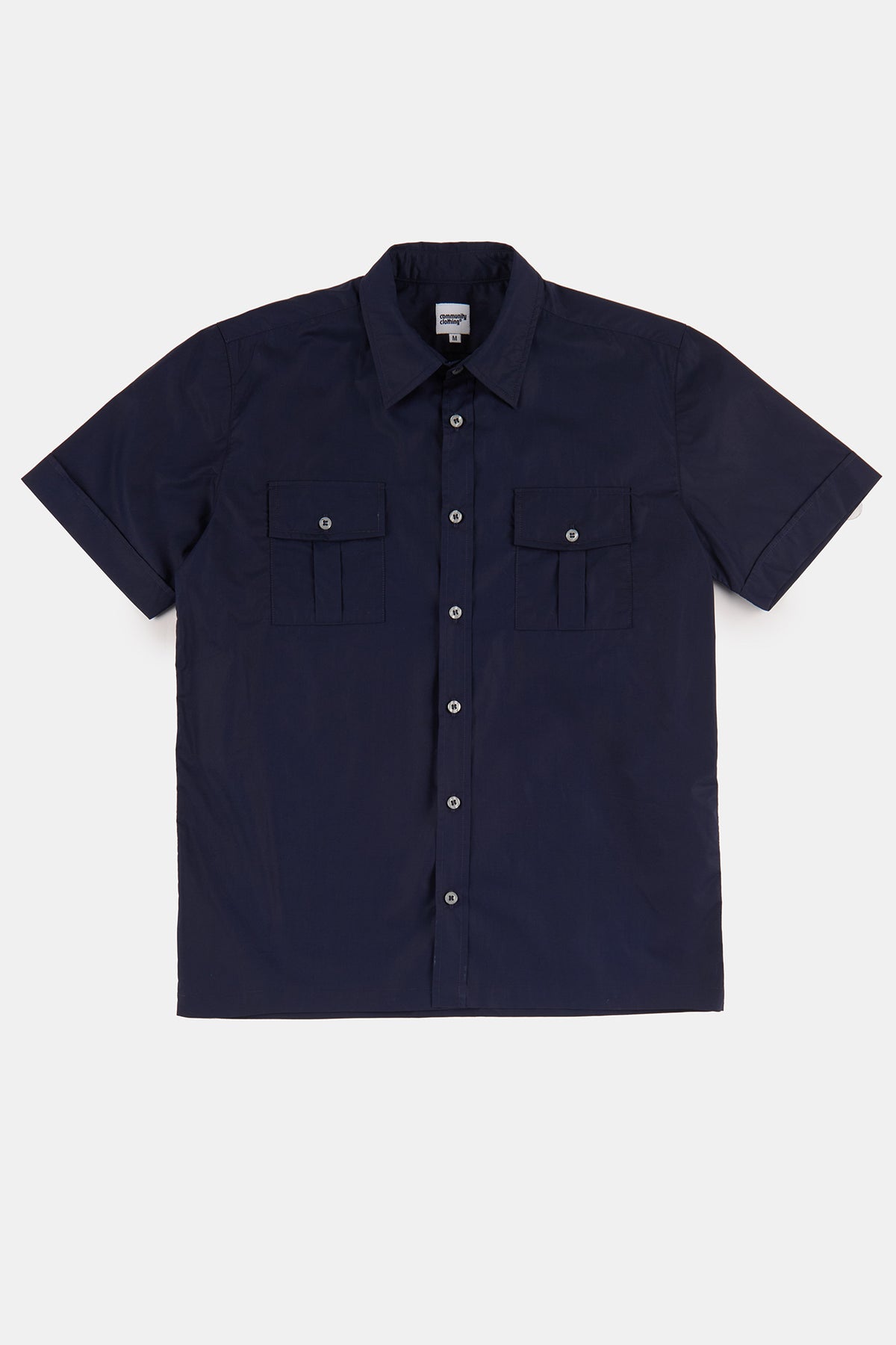 Flatlay product shot of tom short sleeve military two pocket shirt in navy