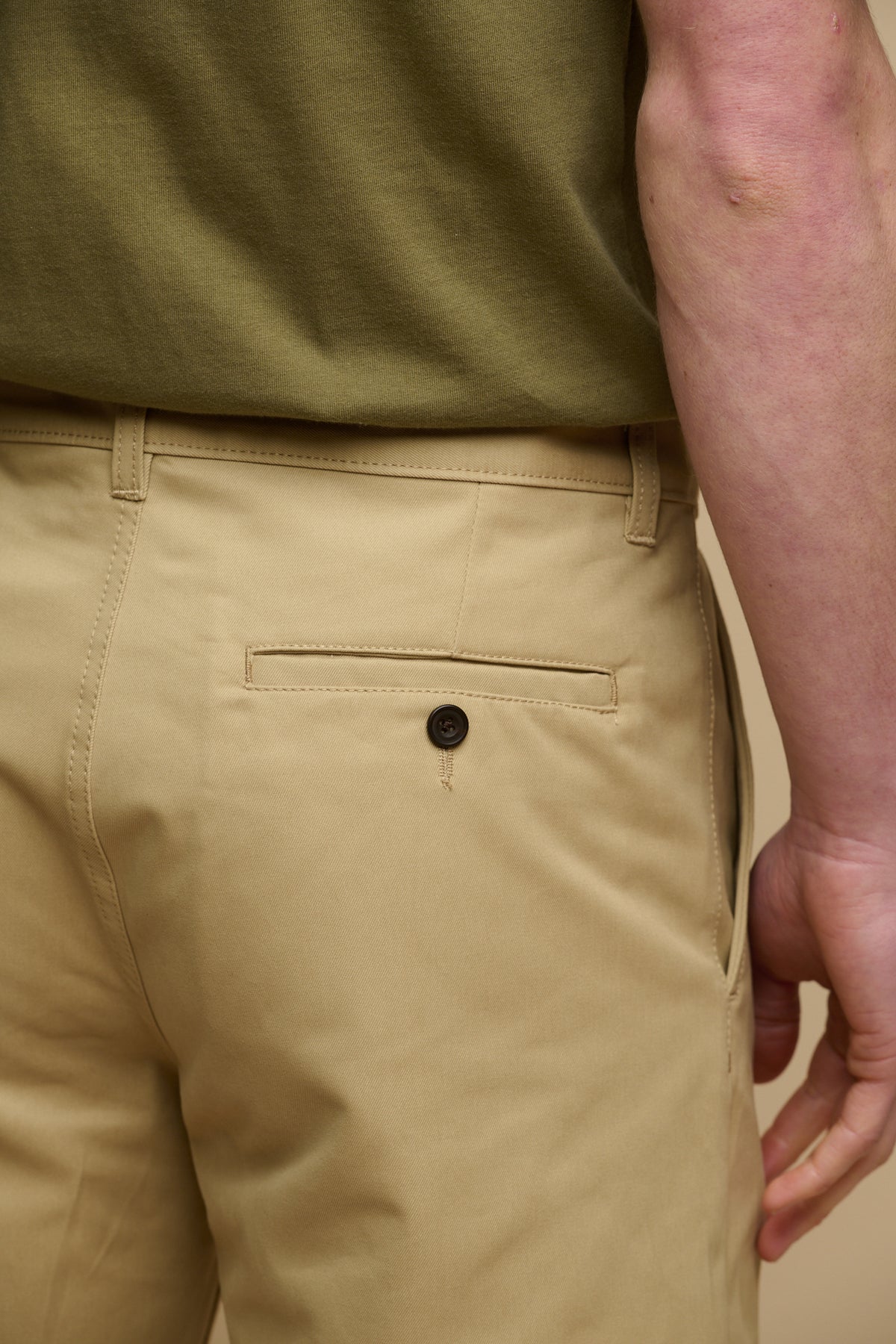 Close up image of the back of male wearing classic shorts in stone, back pocket with button fastening 