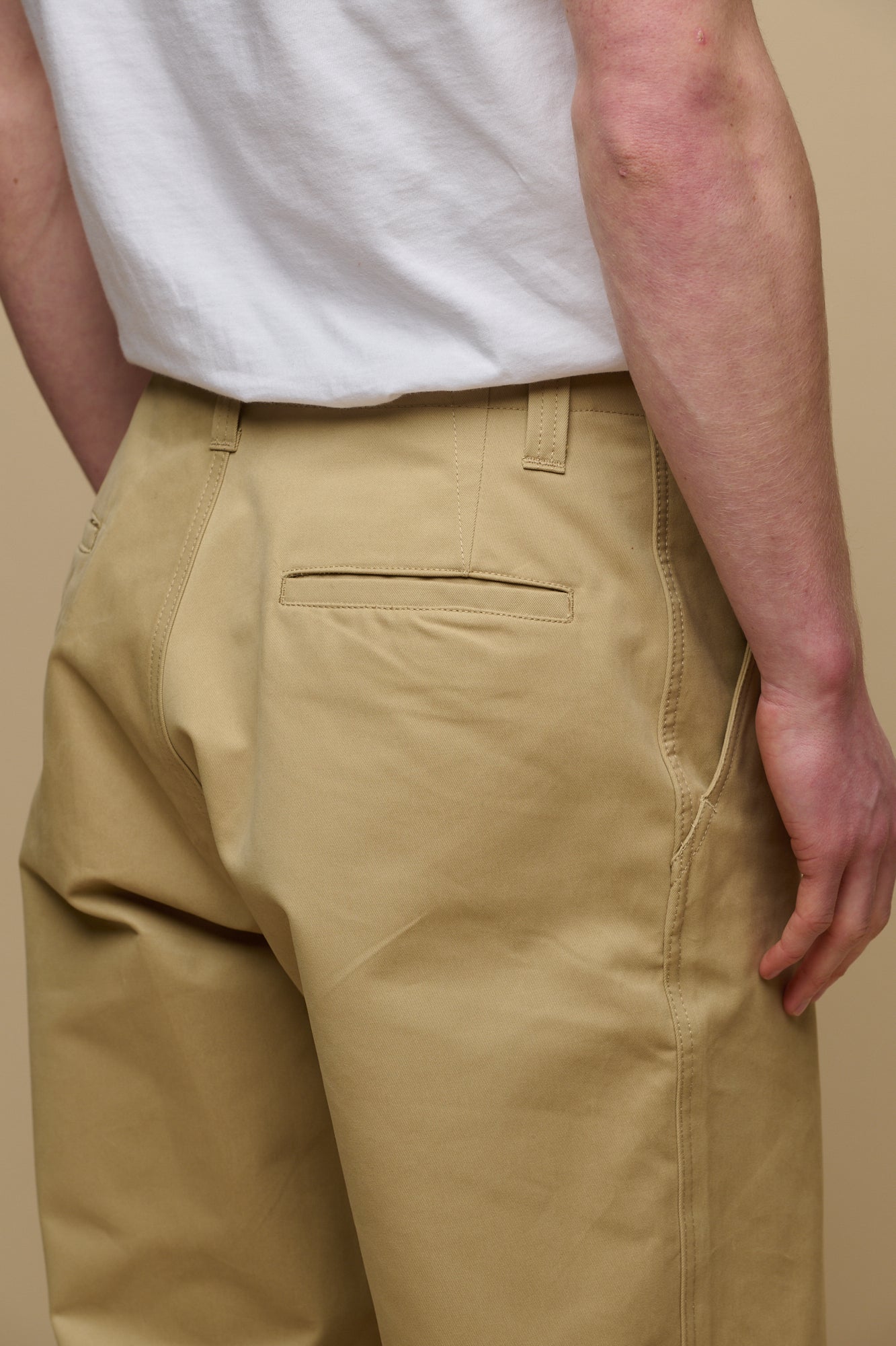 Close up shot of the back pocket detail on the men's field trousers in stone, belt loops on the waistband