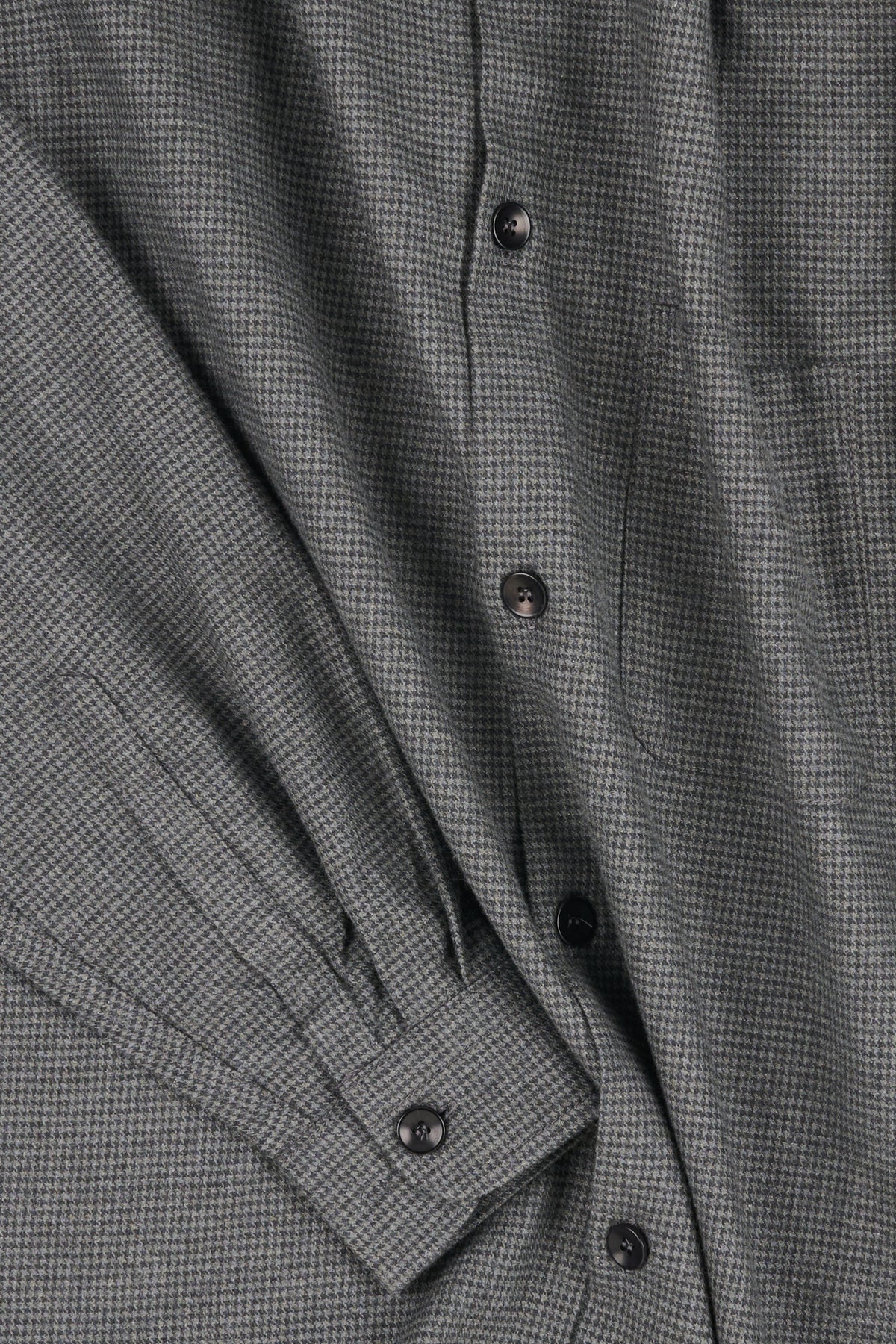 Close-up of a grey puppytooth shirt fabric