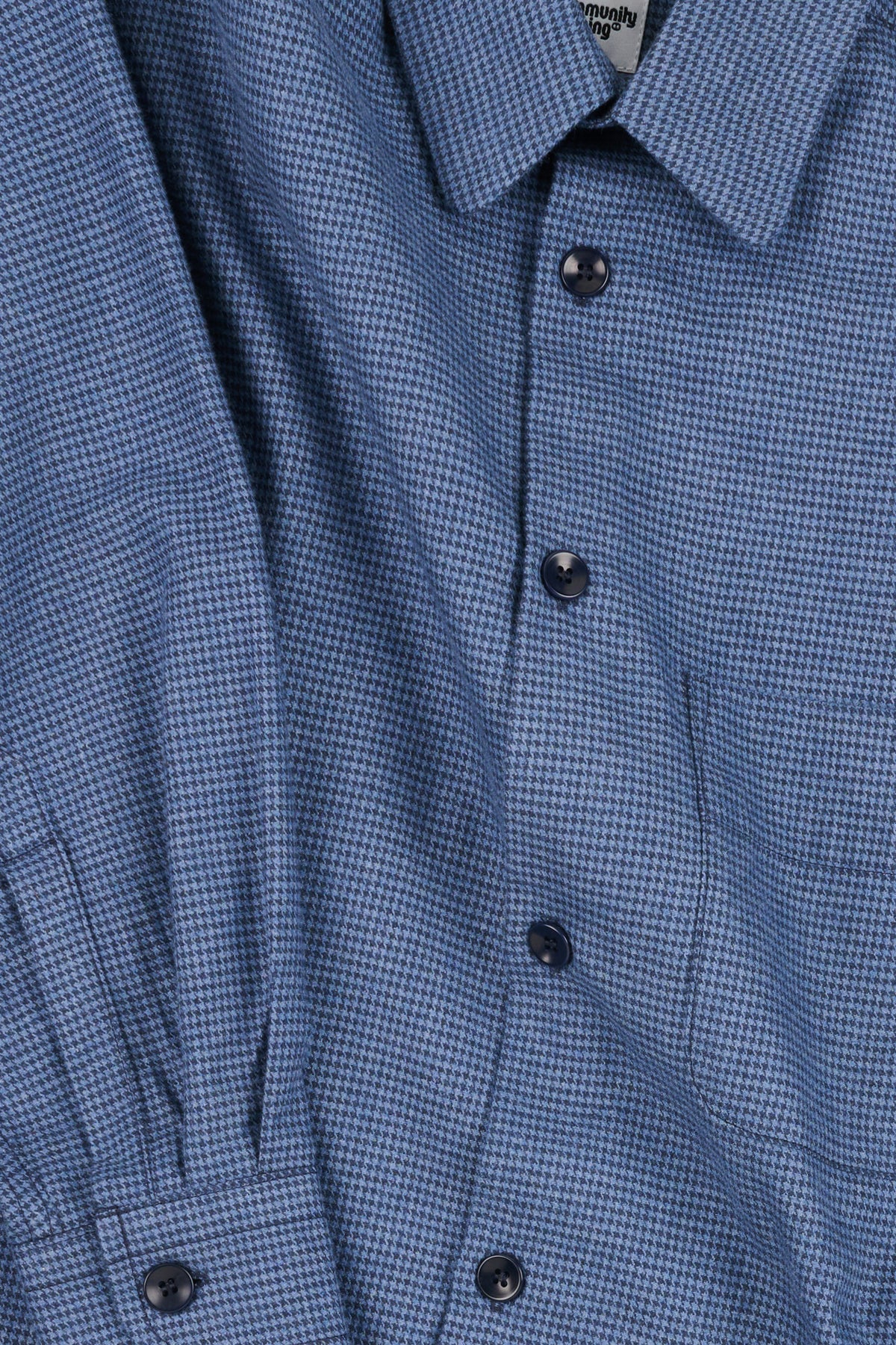 Close-up of a blue puppytooth shirt with buttons