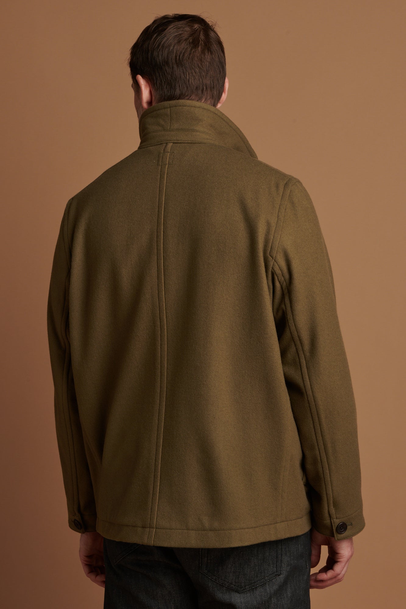 Patrick Grant wearing Community Clothing    Arthur wool chore jacket in olive with the collar up. Worn over lambswool saddle shoulder crew neck in navy.