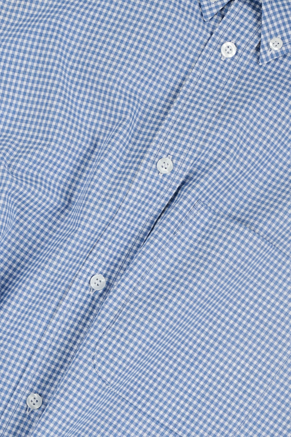 Close-up of a blue checkered shirt with buttons