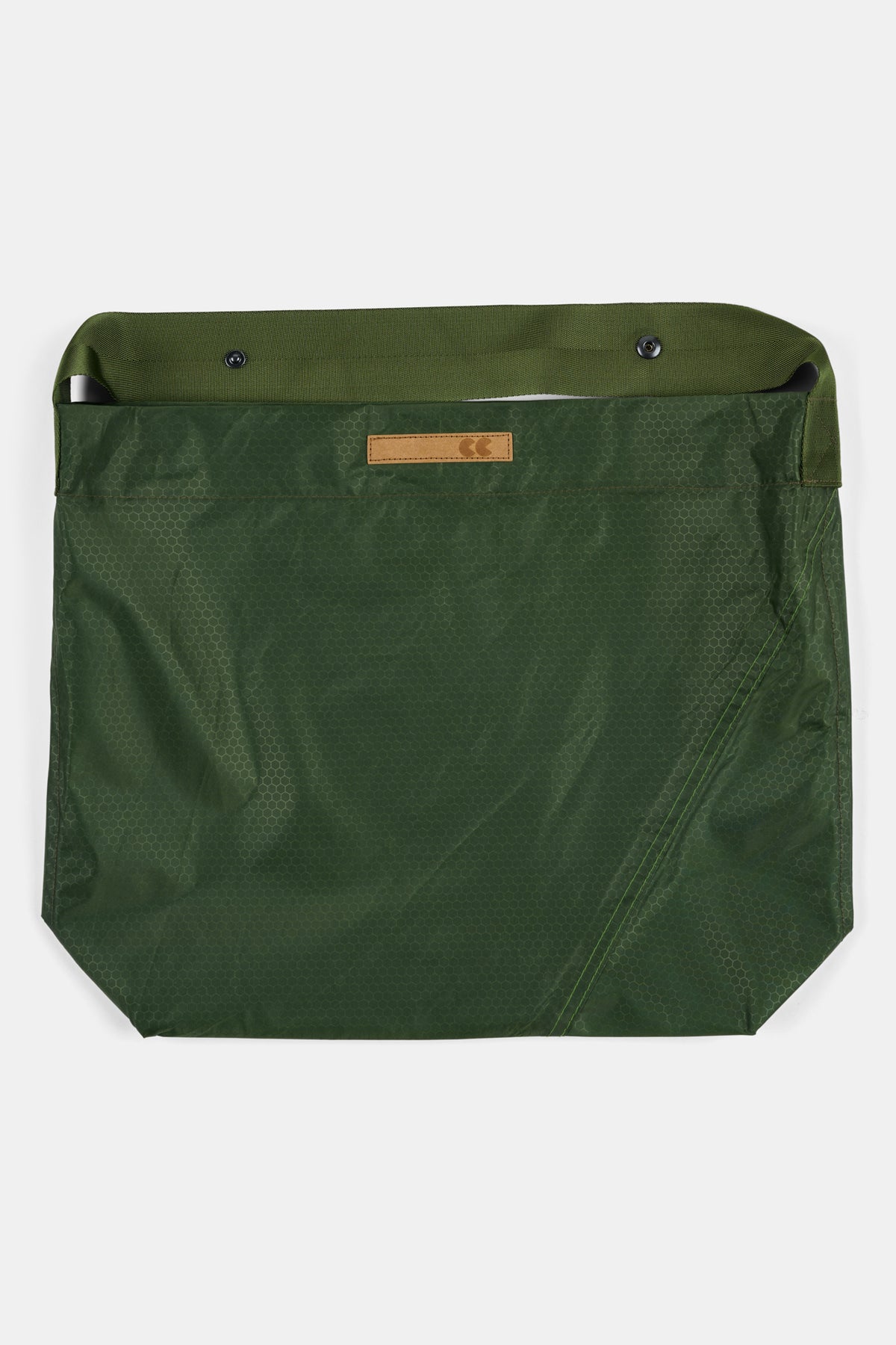 Green bag with a visible brand label on a white background