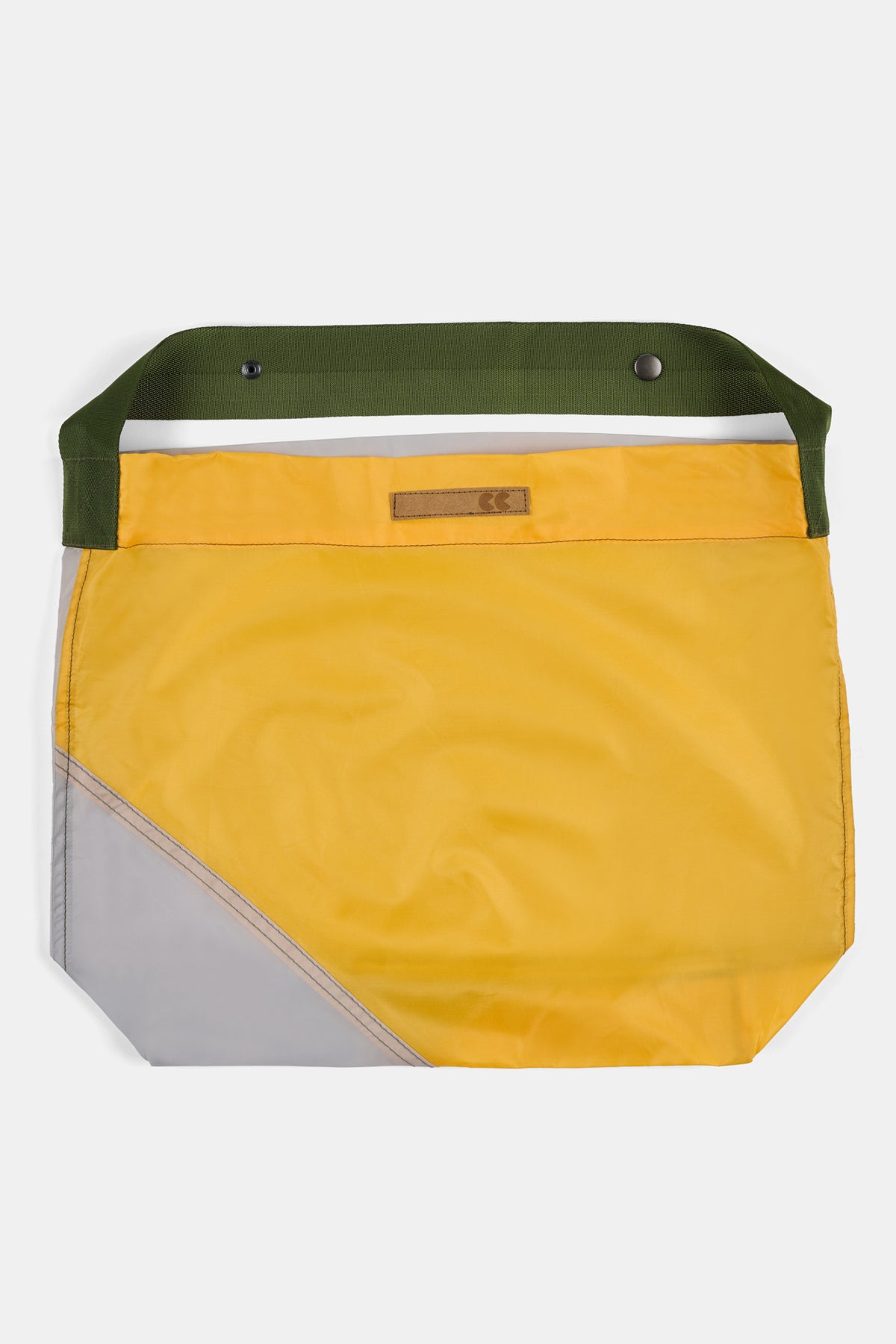 Yellow bag with green strap on a white background