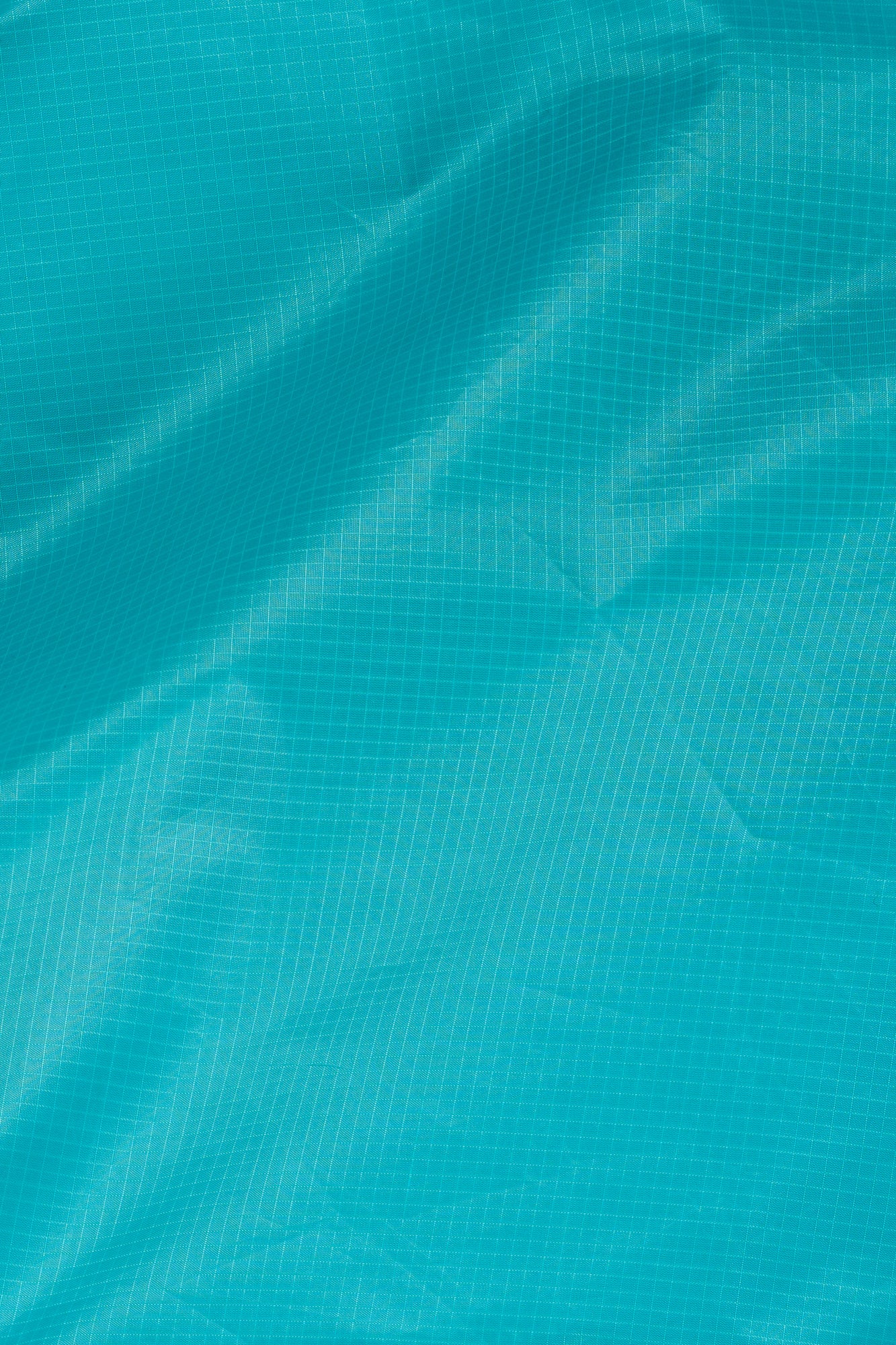 Teal bag with green strap on a white background
