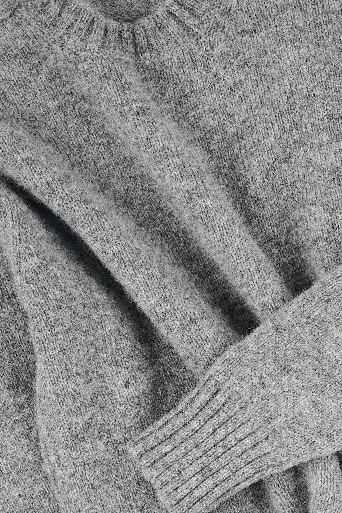 Close up of grey marl knit jumper
