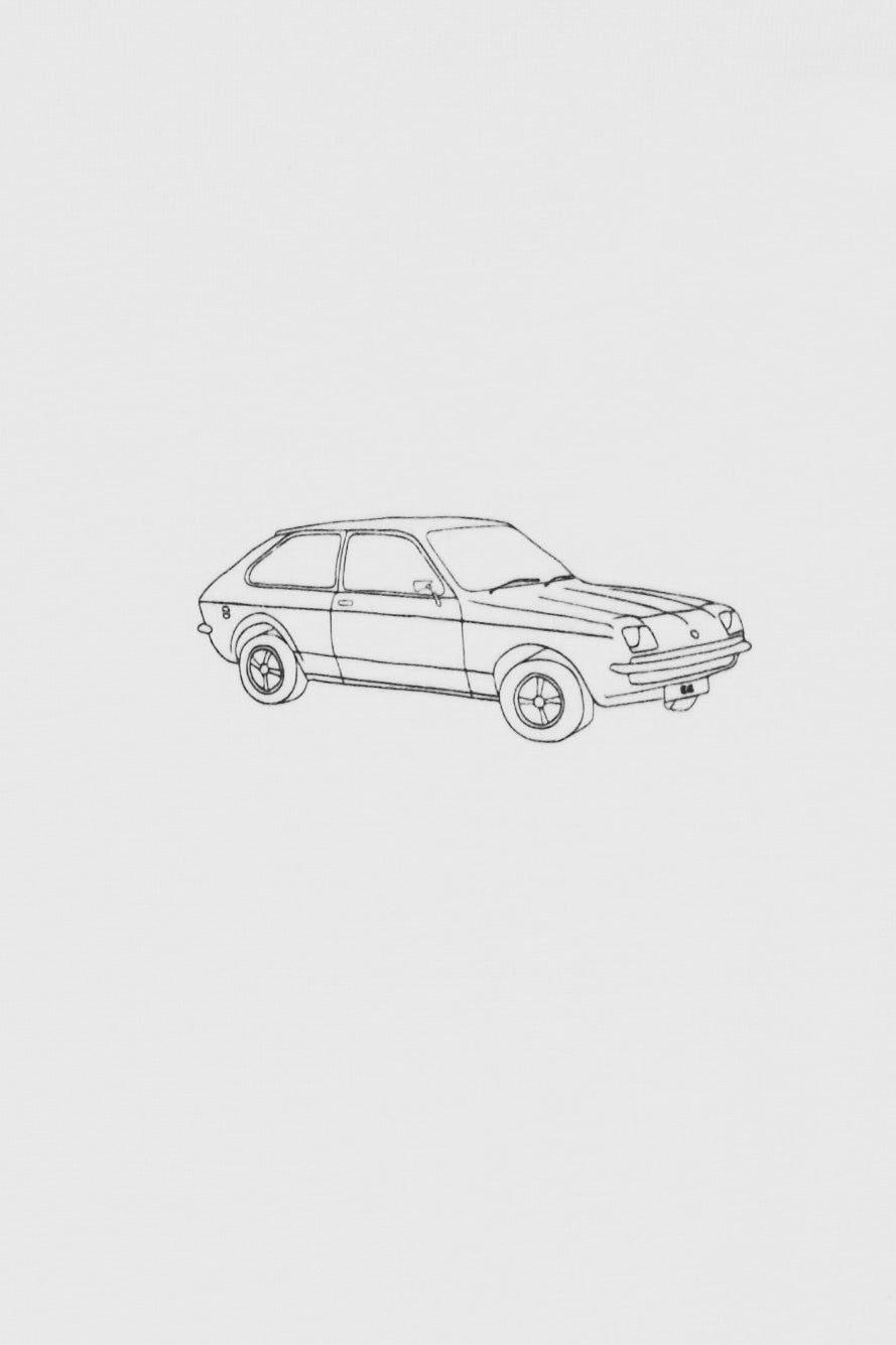 White t-shirt with a small black car graphic print.