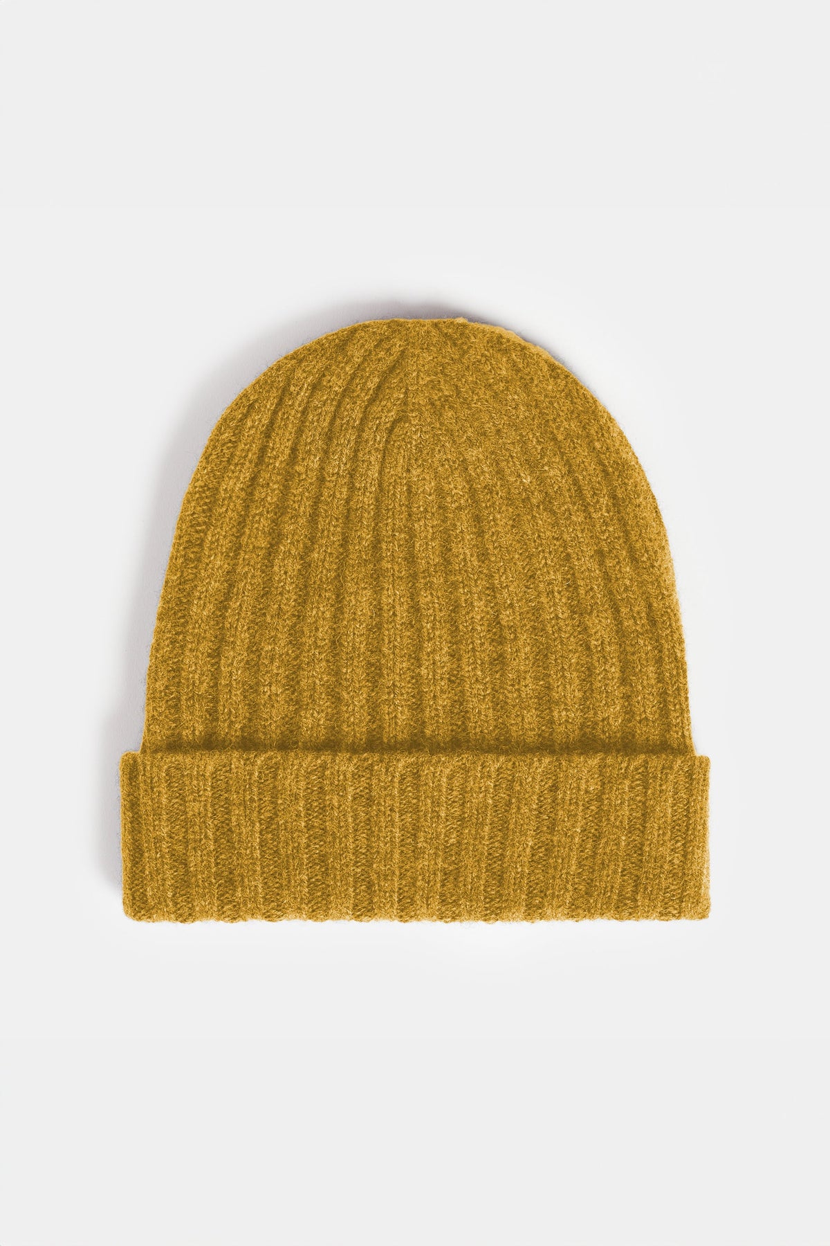flatlay of lambswool beanie hat in mustard 