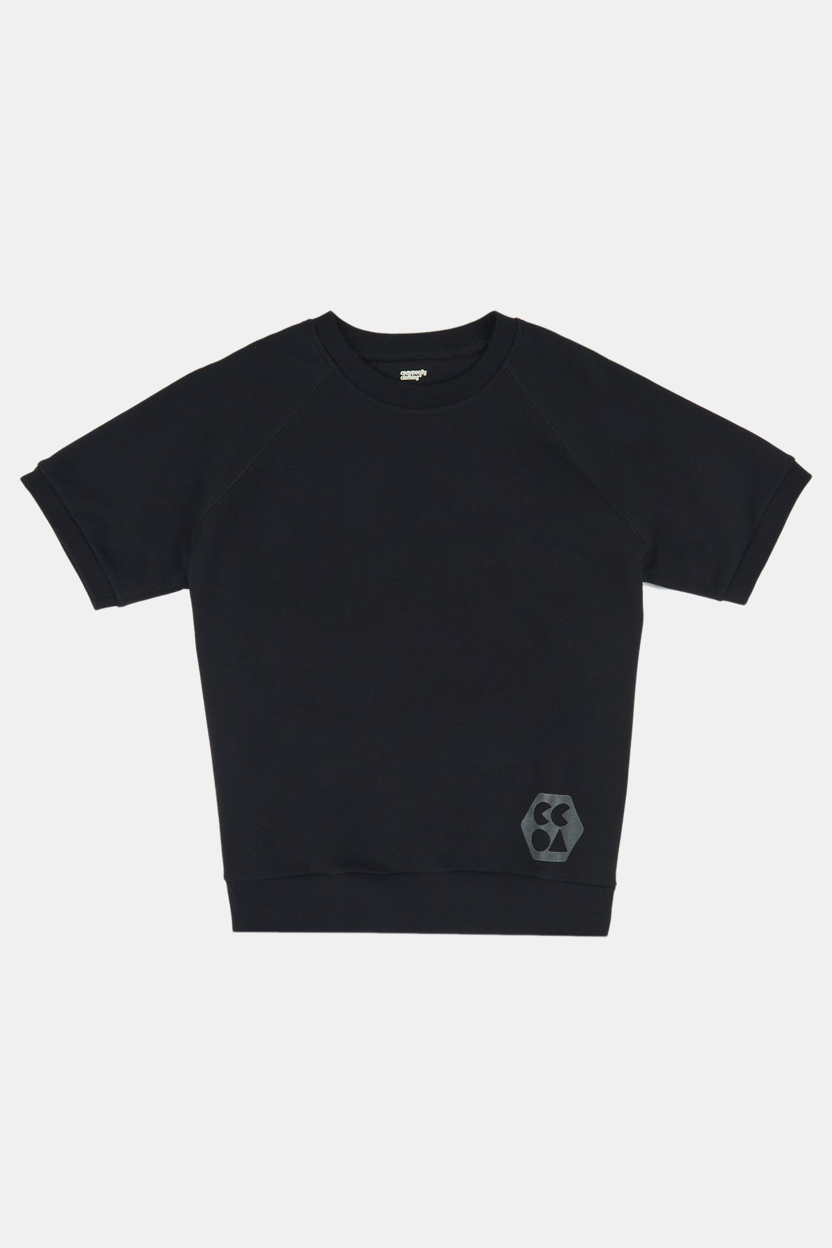 Flatlay product shot of female wearing short sleeve raglan training top plastic free in black with CCOA logo at hem