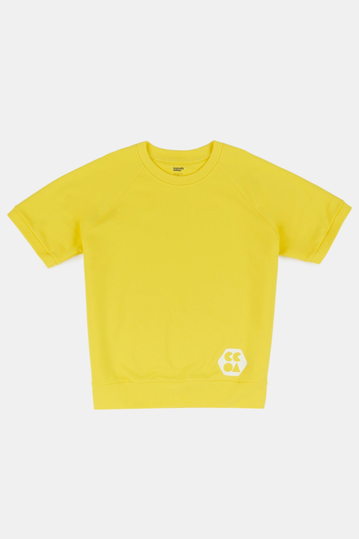 Flatlay product shot of short sleeve raglan training top in canary yellow with white CCOA logo