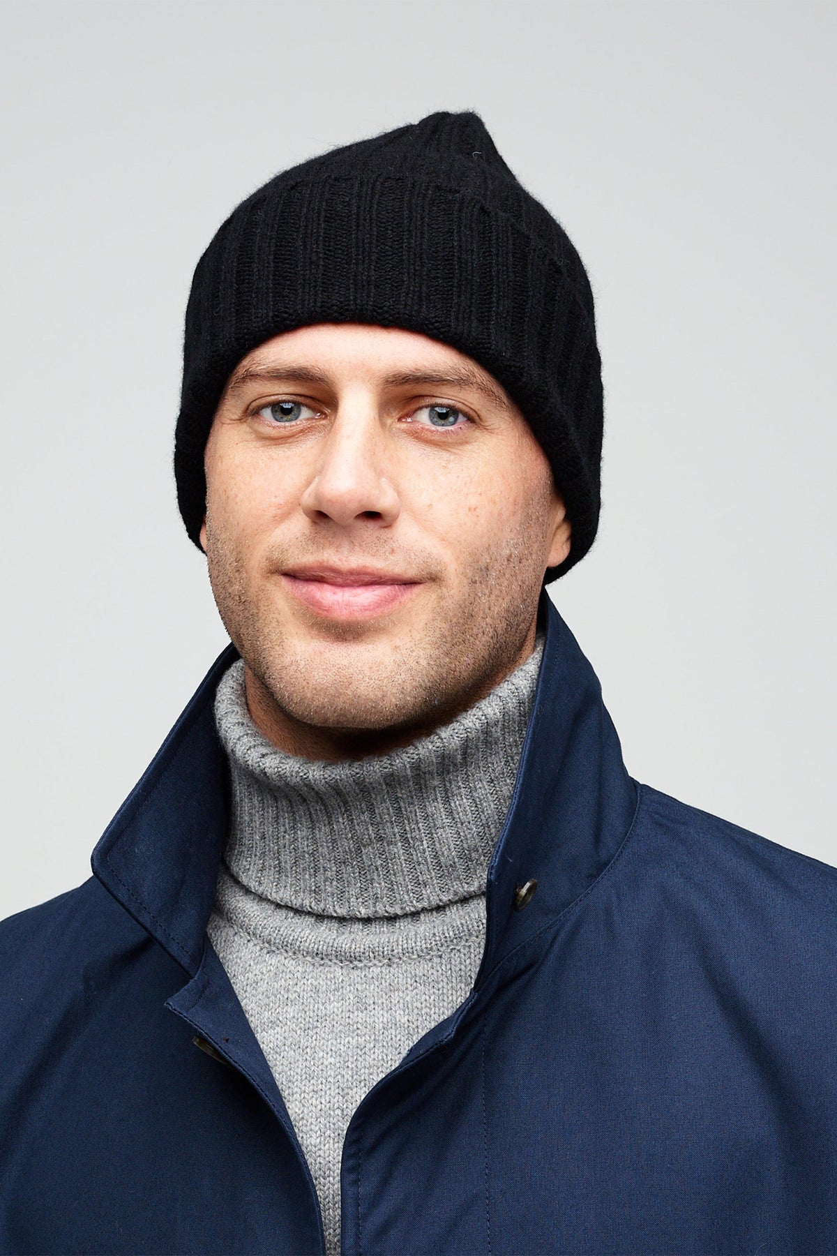 Front portrait of male wearing unisex lambswool beanie hat in black